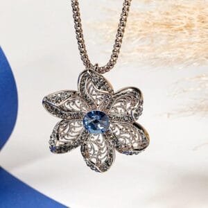 Collier pendentif fleur femme en acier inoxydable couleur bronze avec pierre bleue scintillante